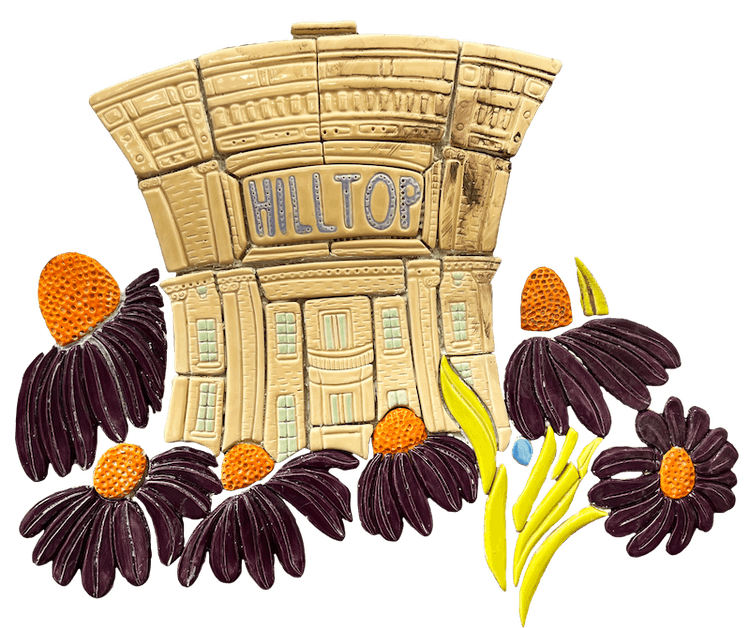 Tile of the old Hilltop Theatre building surrounded by purple coneflowers