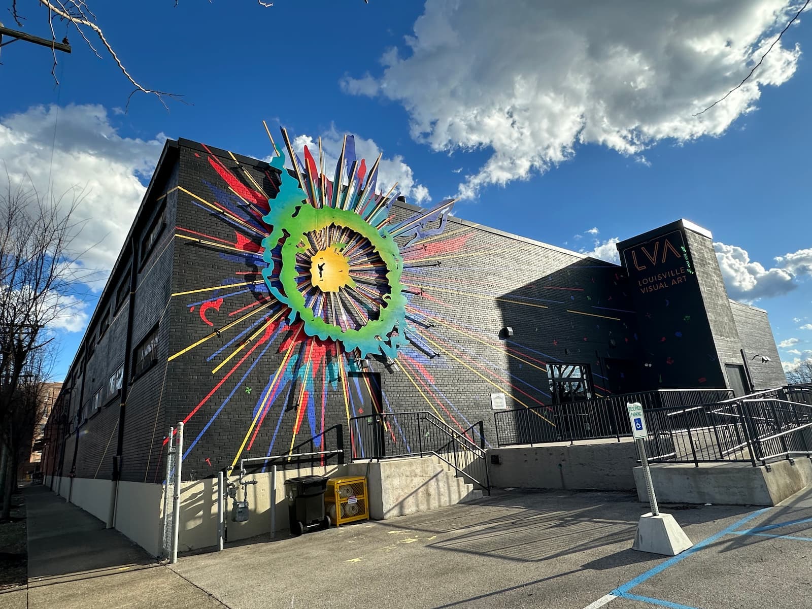LVA's facility featuring a colorful starburst sculpture on its exterior wall